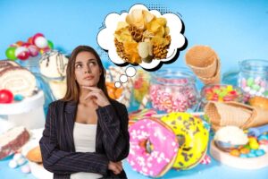 sfondo in cui si vedono tanti dolci e in primo piano una donna che pensa a del cibo salato